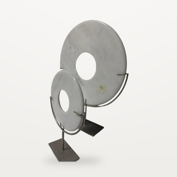 two white marble discs on metal stands