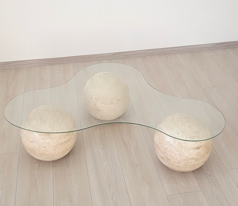 coffee table with three travertine spheres and a glass top, view 2