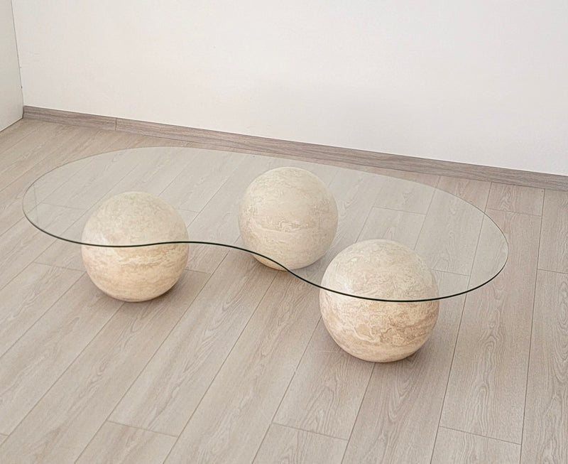 coffee table with three travertine spheres and a glass top, view 3