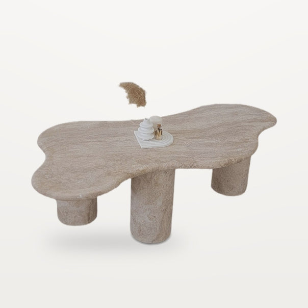 travertine coffee table with freeform top and four legs
