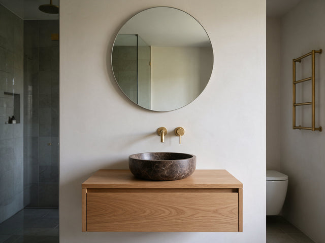 Marble vessel sink on a stone vanity in a calm bathroom
